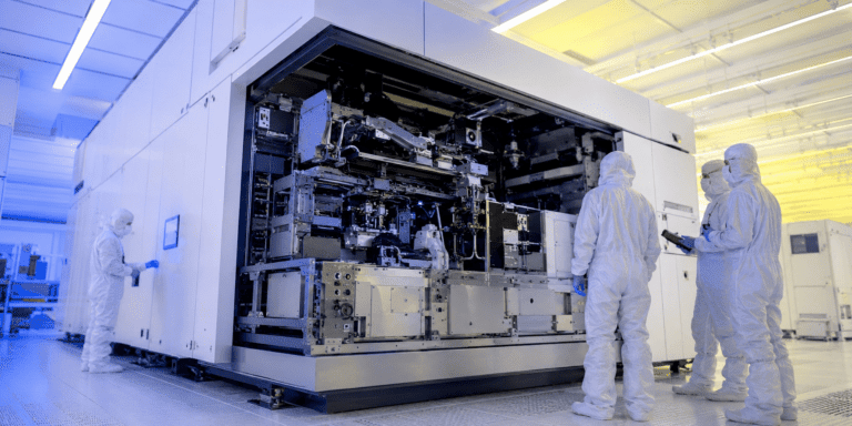 Close-up of a semiconductor DUV lithography machine exposing a silicon wafer under deep ultraviolet light inside a modern chip manufacturing cleanroom.